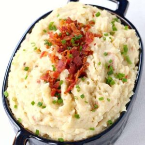 These Slow Cooker Cheesy Bacon Mashed Potatoes are so cheesy and so creamy, you'll be making them over and over!