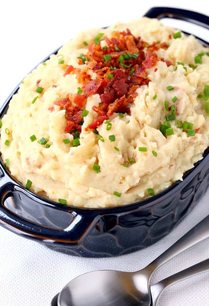 Loaded Slow Cooker Mashed Potatoes served in a blue dish
