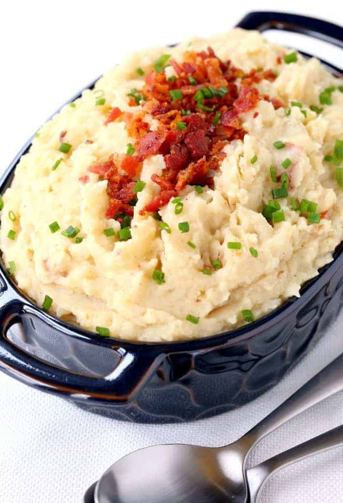 Loaded Slow Cooker Mashed Potatoes served in a blue dish