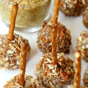 Meatballs with a pretzel stick and mustard