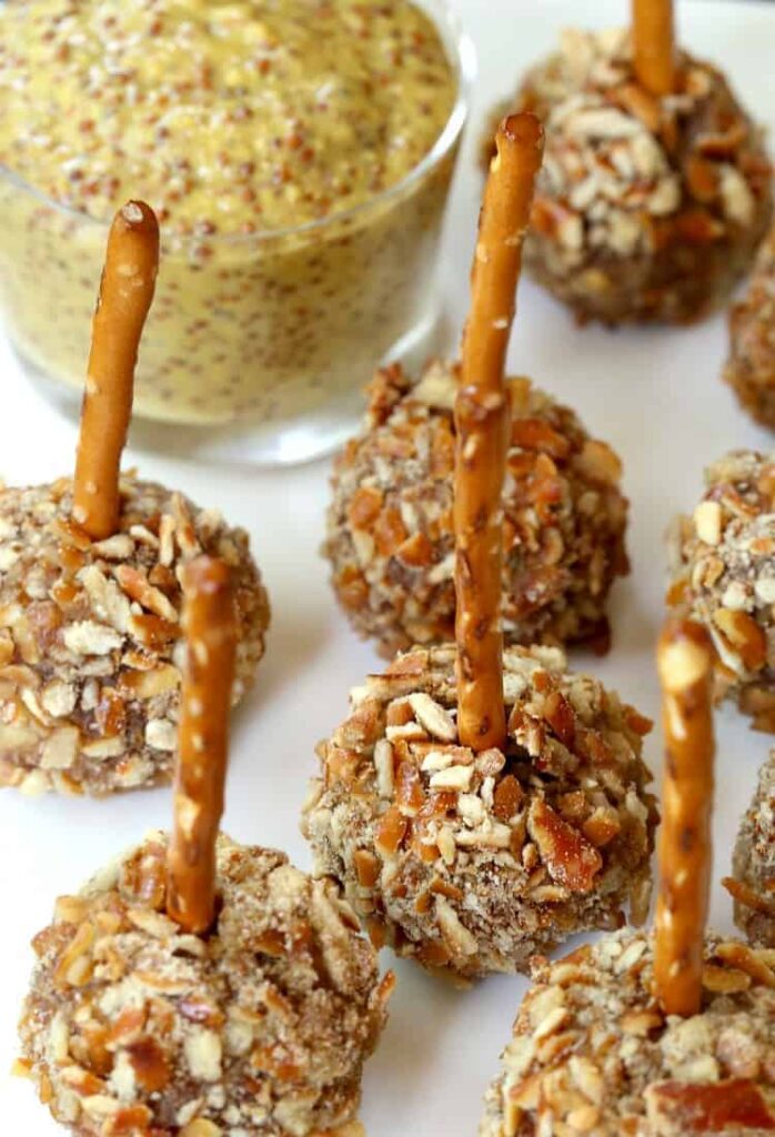 These Beer and Pretzel Cocktail Meatballs are a meatball appetizer recipe with a pretzel stick