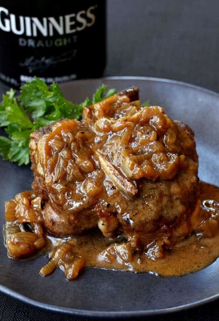 Beer Braised Lamb Chops are braised in dark beer, beef broth and cream with caramelized onions