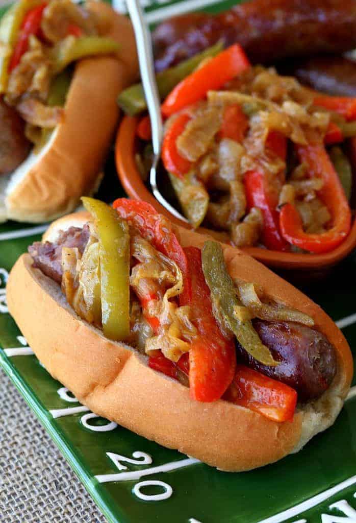 German Style Sausage and Peppers are grilled bratwurst topped with a pepper and onion topping