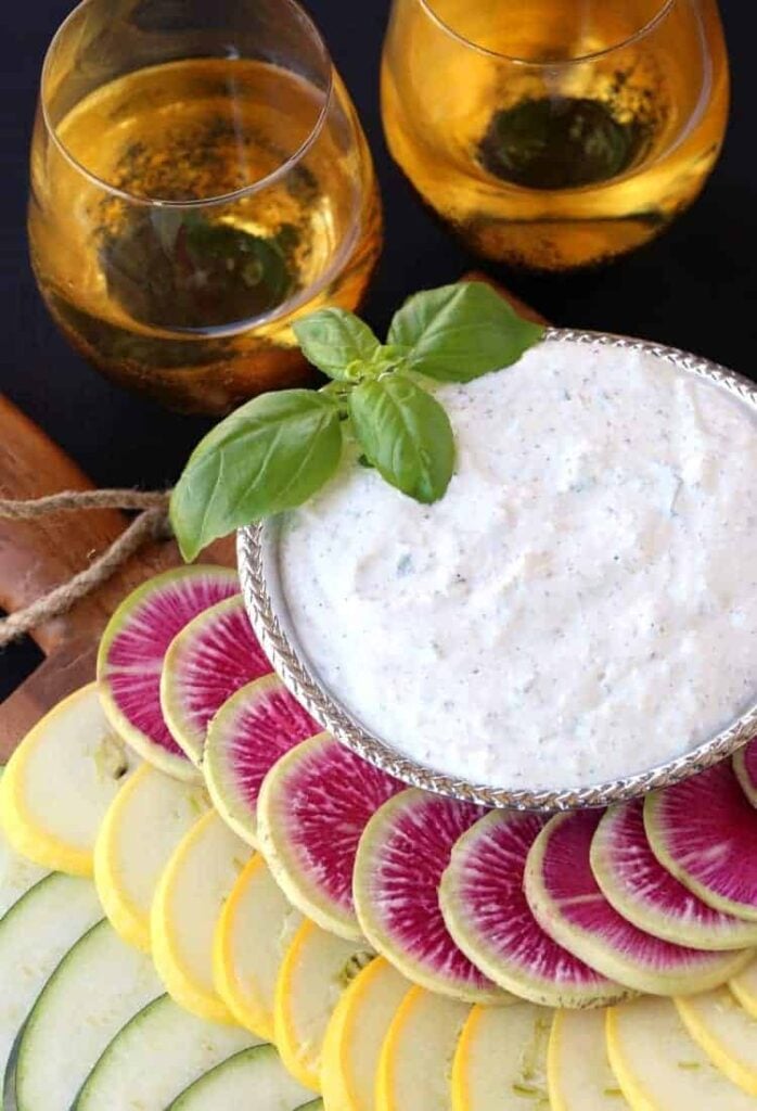 Fresh Ricotta Vegetable Dip in bowl with wine glasses