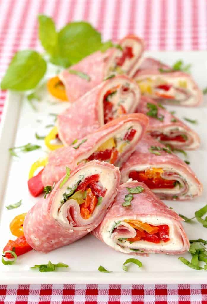 Italian Deli Roll Ups on a plate with chopped basil