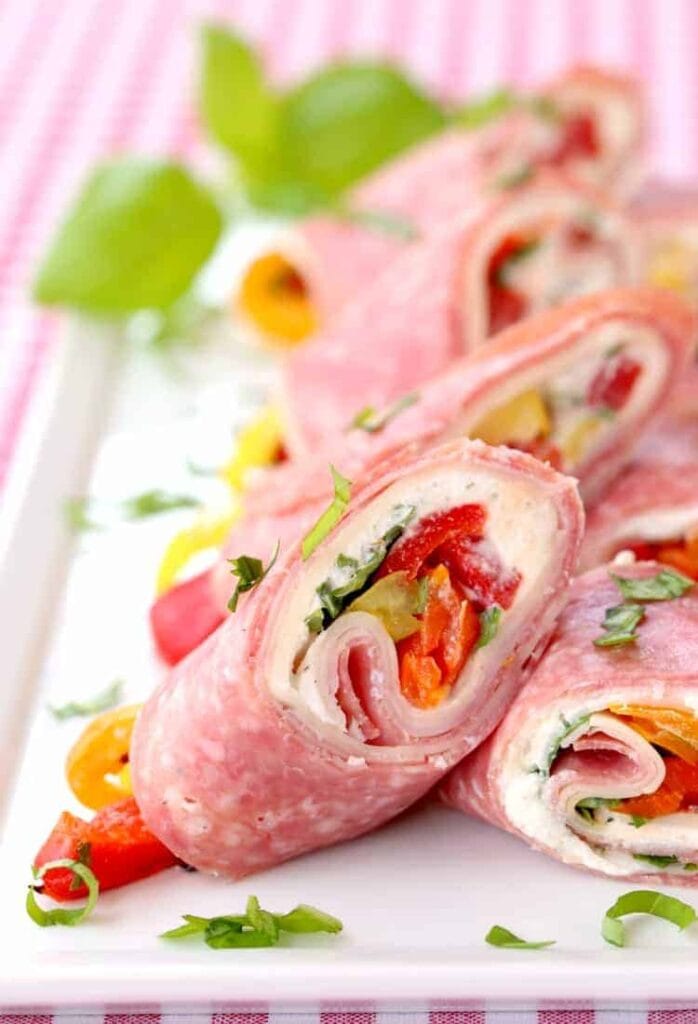 Italian Deli Roll Ups sliced for serving on a white plate