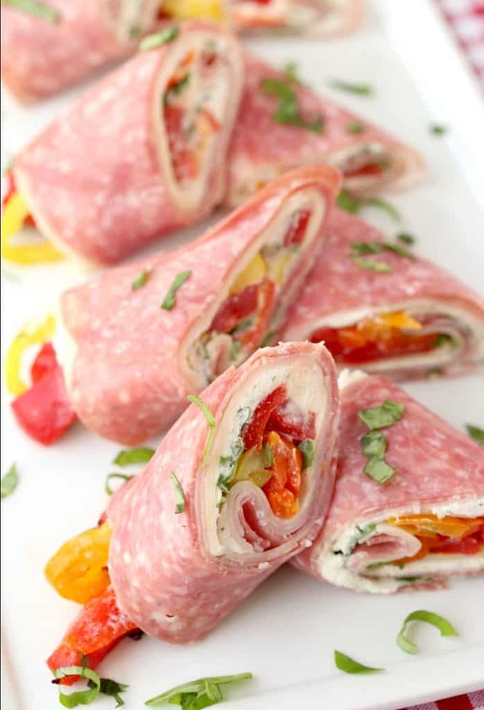 Italian Deli Roll Ups sliced on a white plate from the top