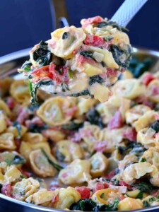 Skillet Tuscan Spinach Tortellini on a big spoon