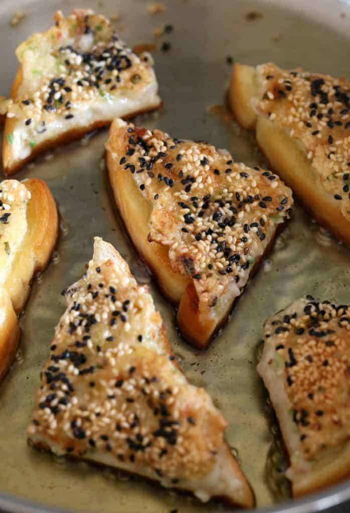 Frying shrimp toast in a pan with oil