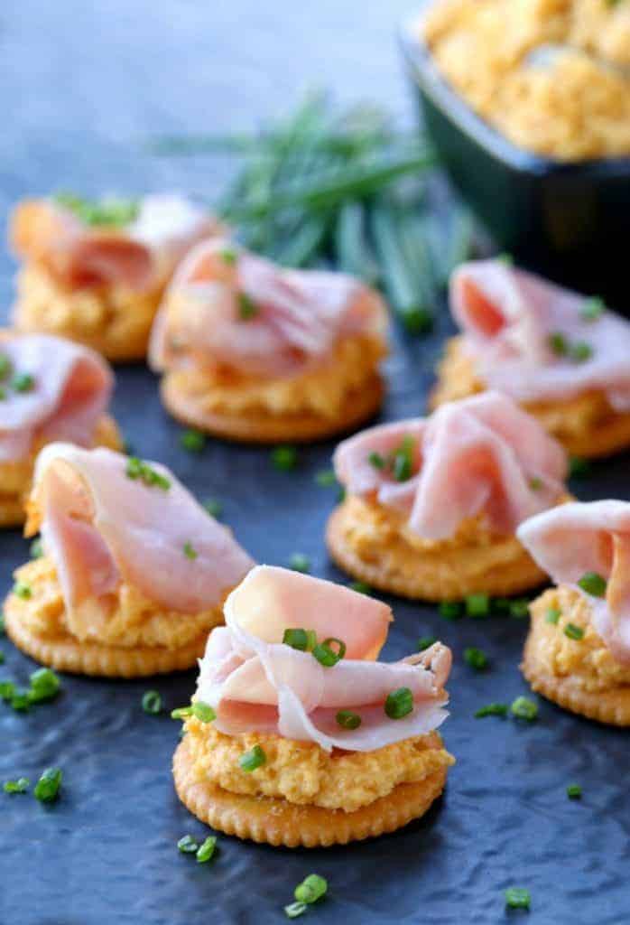 Ham and Pub Cheese Crackers on a cheese board with bowl