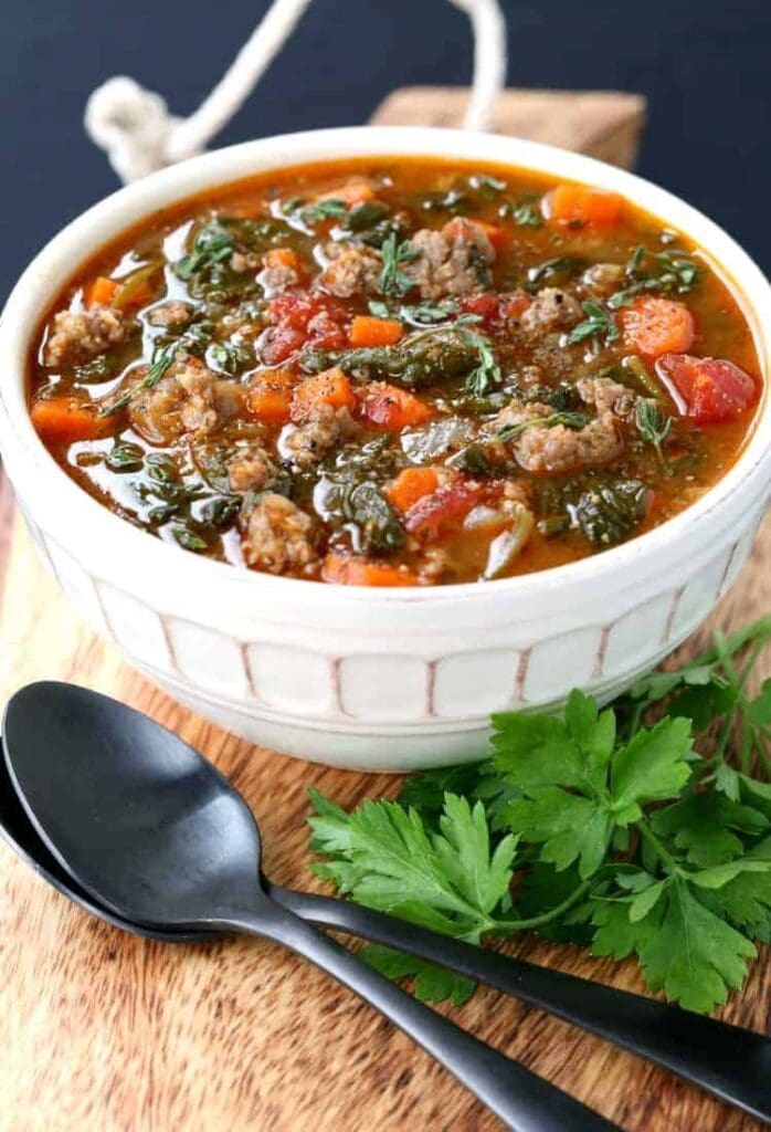 low carb sausage and vegetable soup in white bowl