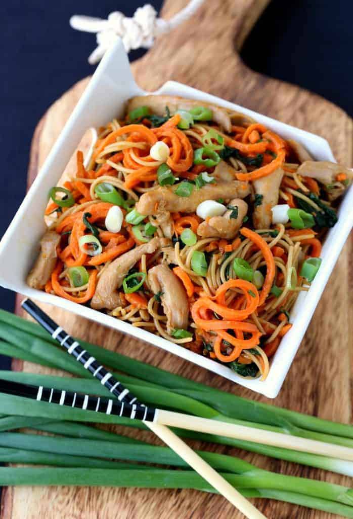 Veggie Heavy Chicken Lo Mein in a bowl with scallions and chop sticks