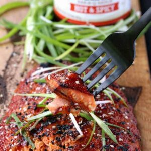 Oven Baked Asian BBQ Salmon with sauce and a fork bite