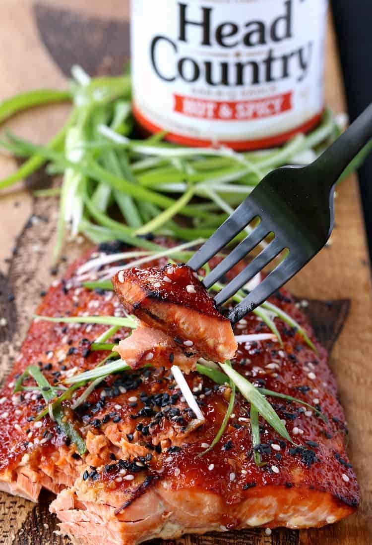 Baked Asian BBQ Salmon with sauce and a fork bite