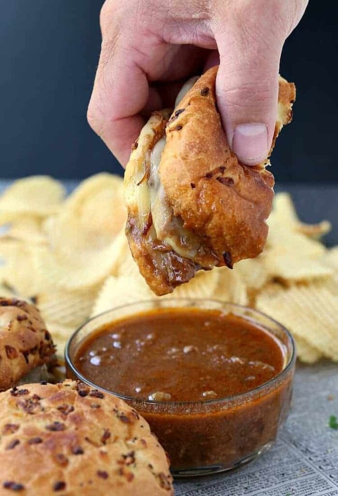 French Dip Sandwiches dipping into au jus