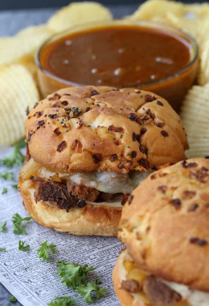Slow Cooker BBQ French Dip Sandwiches on a board with chips