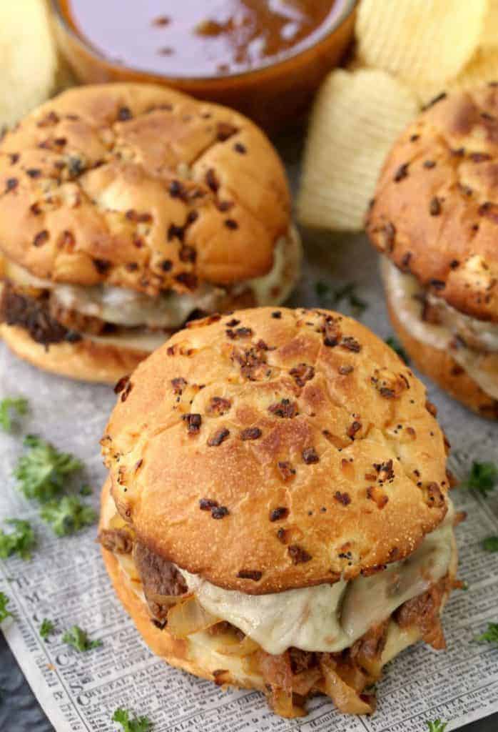 BBQ French Dip Sandwiches from the top on a board with chips