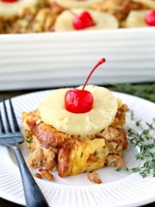 Slice pof pineapple and sausage stuffing on a plate