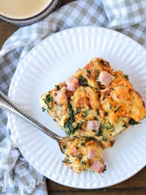 ham and egg breakfast casserole on a plate with fork