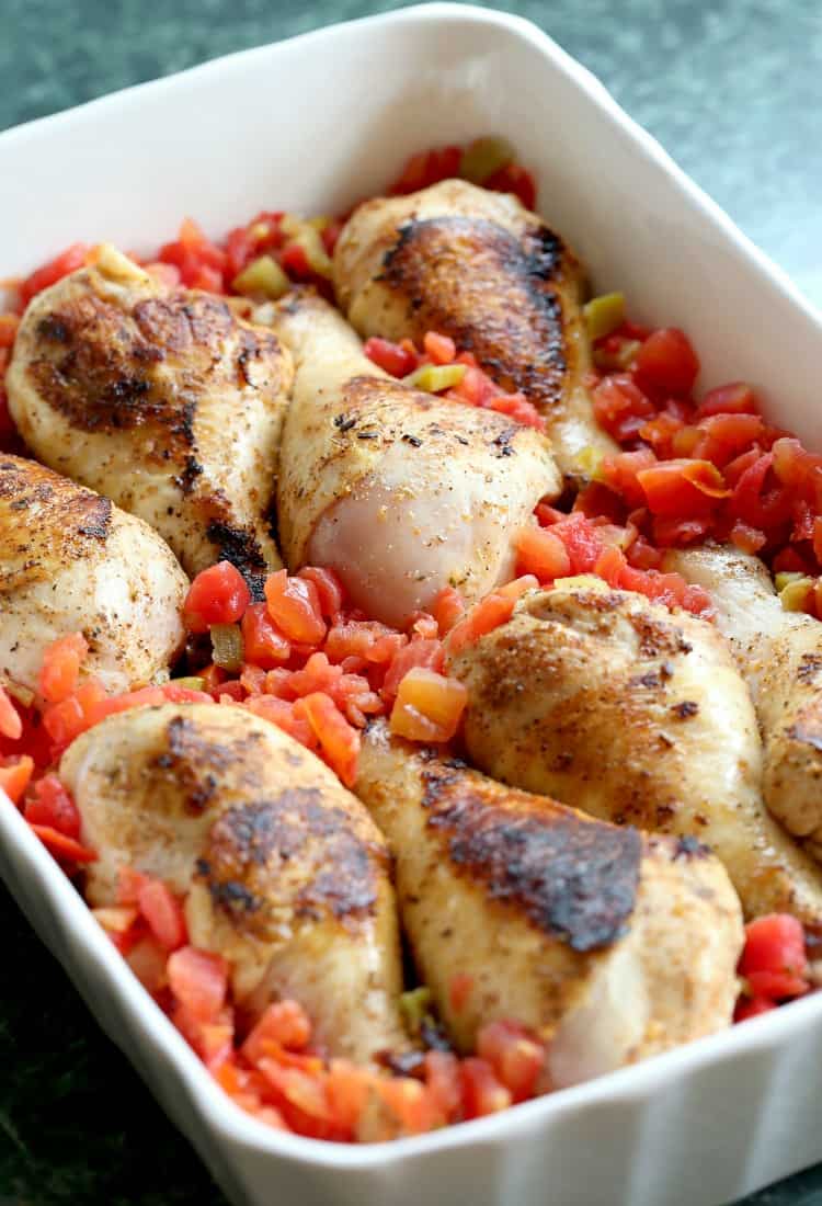 Chicken Legs in baking dish with diced tomatoes