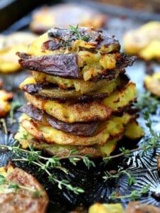 Stick of Butter Smashed Potatoes stacked on a tray