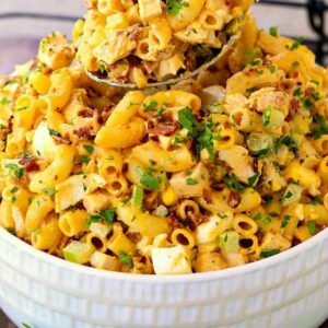 Devilish Buffalo Chicken Pasta Salad in a white bowl with a spoon