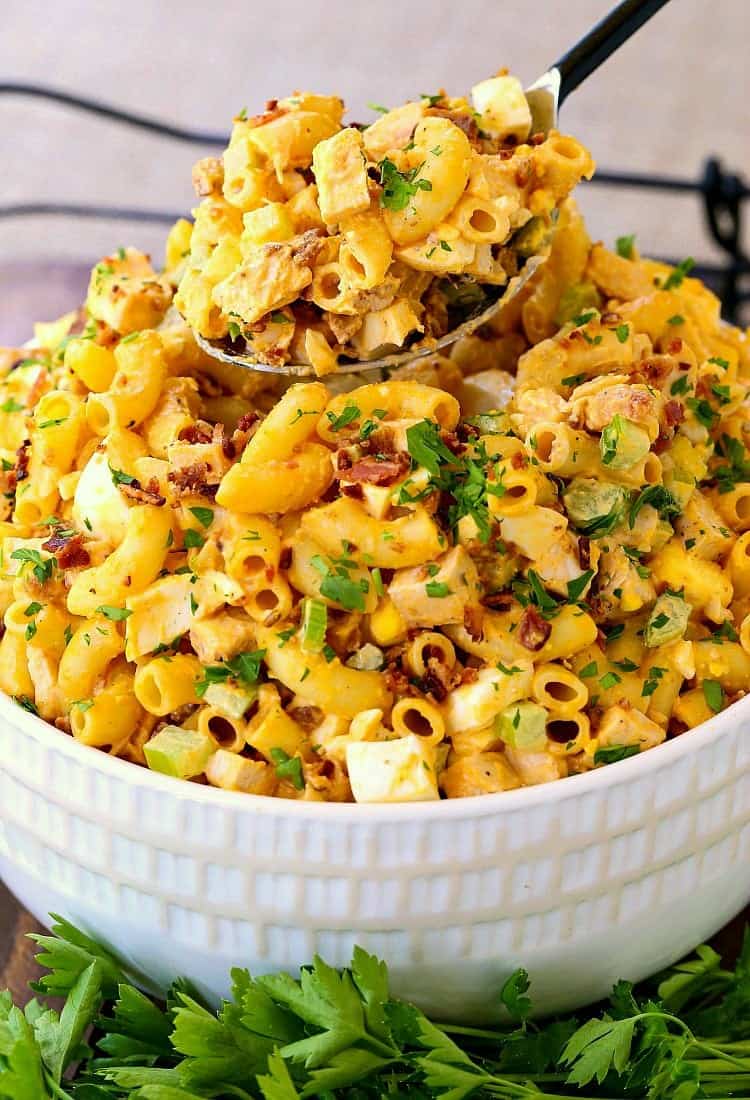 Devilish Buffalo Chicken Pasta Salad in a white bowl with a spoon