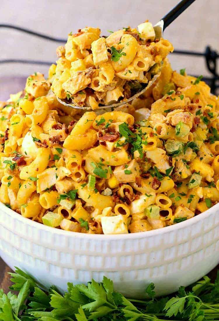 Devilish Buffalo Chicken Pasta Salad in a white bowl with a spoon