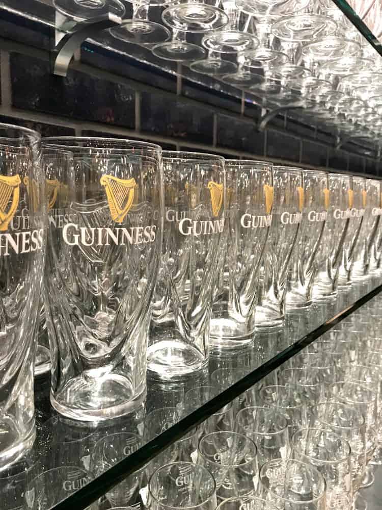 guinness beer glasses on shelf