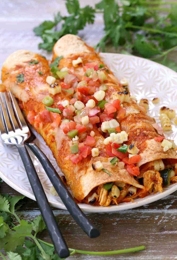 chicken enchiladas on plate with forks