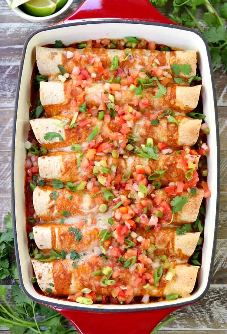 Chicken Enchiladas in baking dish with fresh pico de gallo topping
