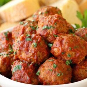 Grandma's Sunday Meatballs and Sauce close up in a white bowl with bread