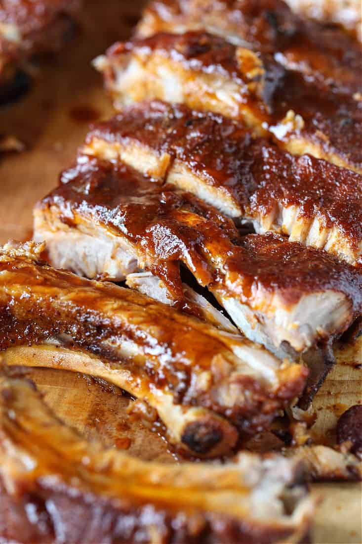 BBQ ribs sliced on a board