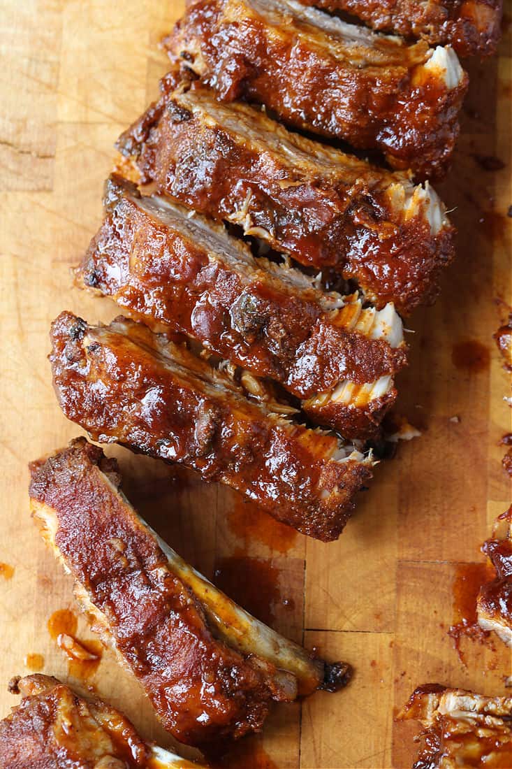 BBQ ribs sliced into pieces on a board