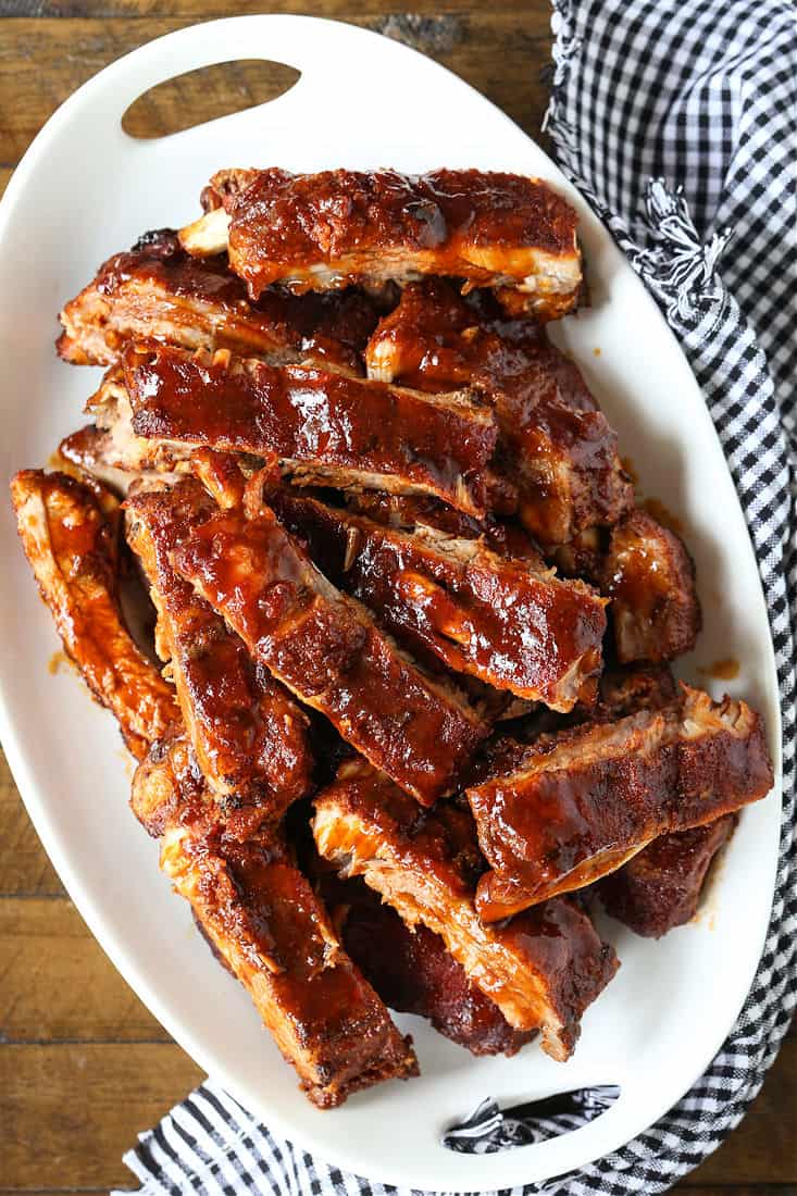 BBQ ribs on a white platter with napkin