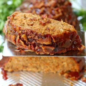 Tasty AF Turkey Meatloaf (TAFTM) on a spatula in front of meatloaf