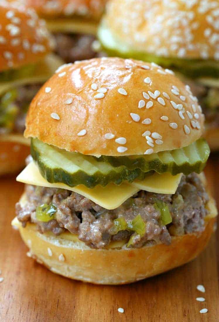 A ground beef slider with pickles and cheese