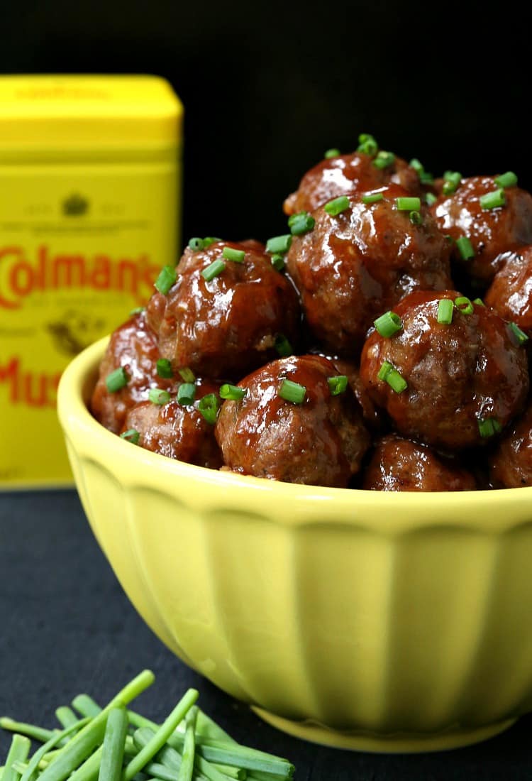 cocktail meatballs in yellow bowl with dry mustard