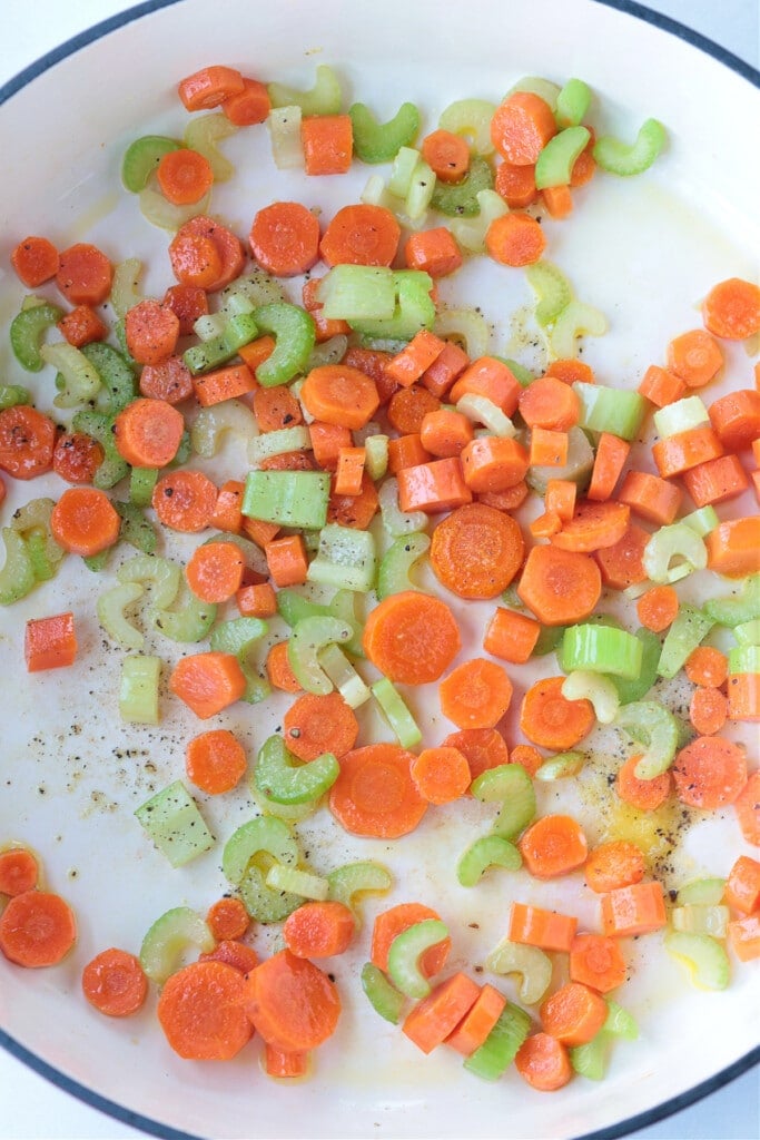 carrots, onions and celery in a pot to make turkey soup