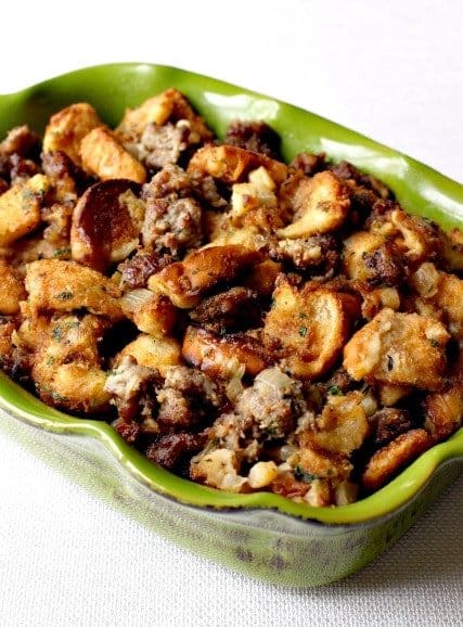 This sausage stuffing recipe is so good we make it for Thanksgiving AND throughout the year. Made with apples, Italian sausage & bread, we can't get enough. #thanksgiving #stuffing #sidedish