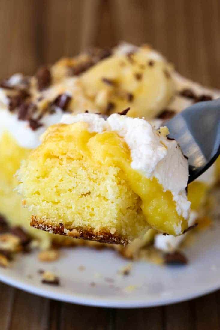 Banana Bourbon Poke Cake is an easy party cake recipe with whipped cream, pudding and bananas