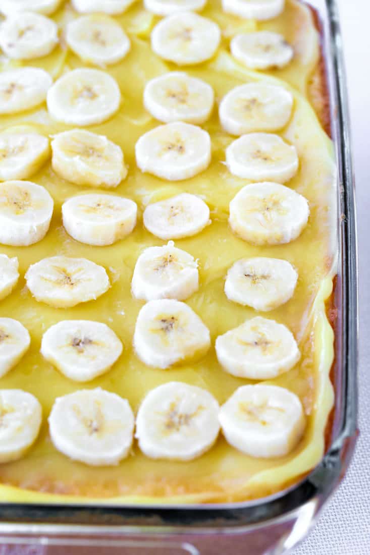 Banana Bourbon Poke Cake is an easy dessert recipe that uses boxed cake, pudding and bananas