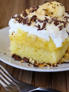 Banana Bourbon Poke Cake is an easy dessert recipe with layers of whipped cream and banana pudding