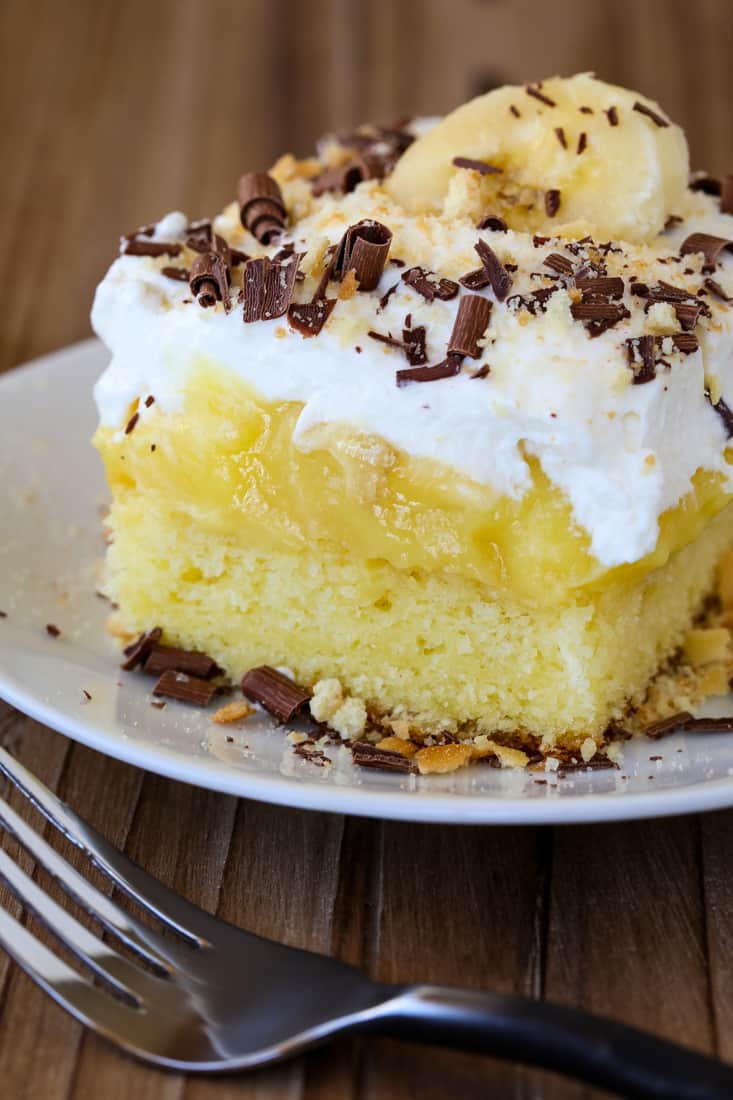 Banana Bourbon Poke Cake is an easy dessert recipe with layers of whipped cream and banana pudding
