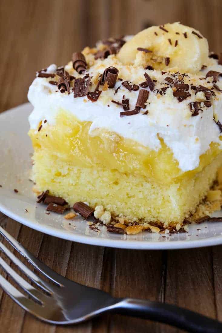 Banana Bourbon Poke Cake is an easy dessert recipe with layers of whipped cream and banana pudding