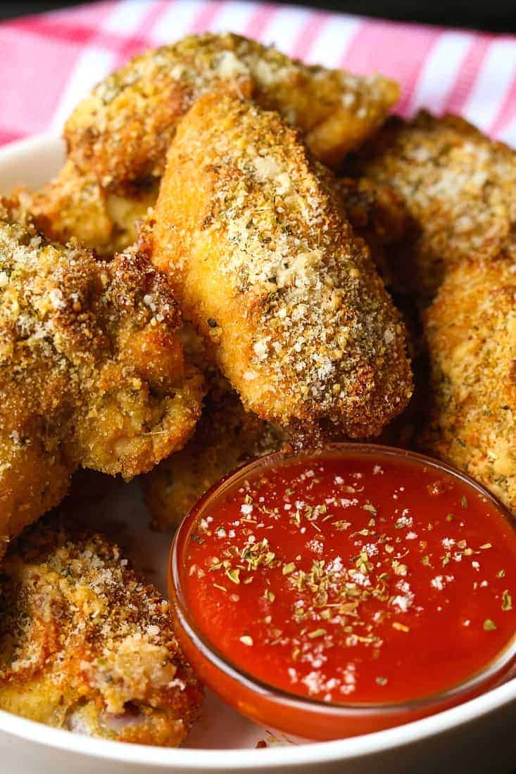 These Baked Chicken Wings are the crispiest oven baked wings ever! A crispy parmesan-panko crust coats tender and juicy chicken wings! Baked chicken wings with marinara sauce