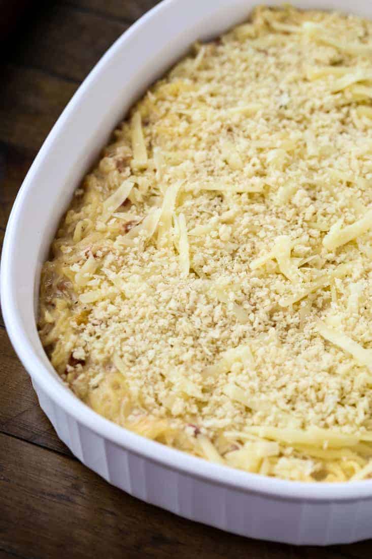 spaghetti squash casserole topped with bread crumbs and cheese