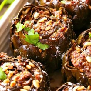 Grandma's Best Stuffed Artichokes are a side dish stuffed with sausage, cheese and pine nuts