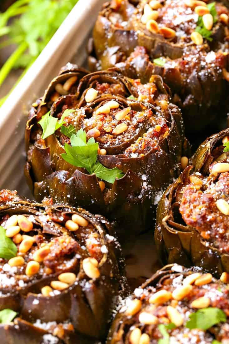 Grandma's Best Stuffed Artichokes are a side dish stuffed with sausage, cheese and pine nuts