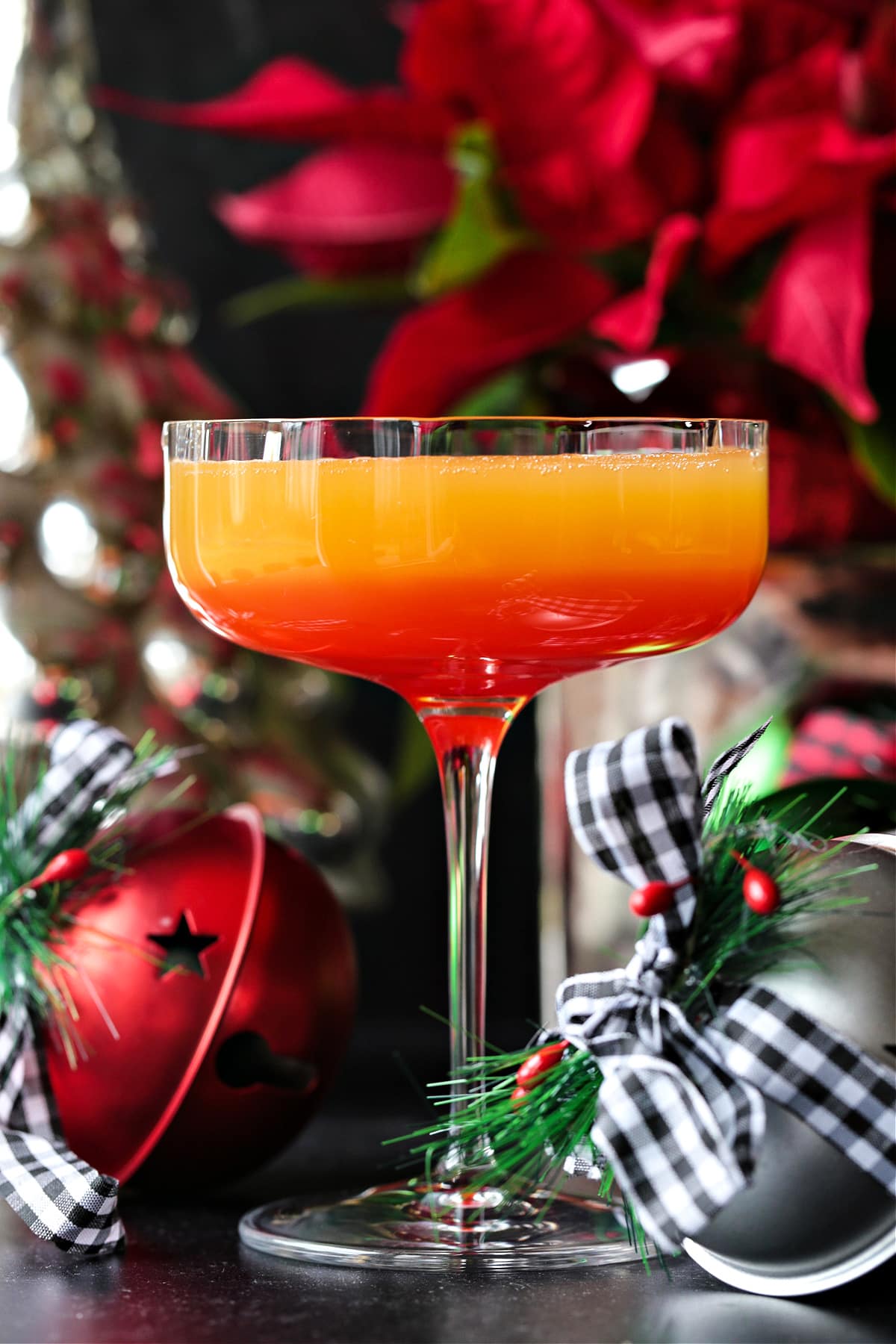 This Christmas Mimosa Recipe is perfect for your holiday parties and brunches! A beautiful, layered cocktail that tastes as good as it looks! mimosa with layer of grenadine on the bottom